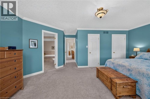 Recessed built-in bathtub, light-colored carpeting, white trim, and a semi-flush mount ceiling light fixture - 10 Balvenie Boulevard, Caledonia, ON 