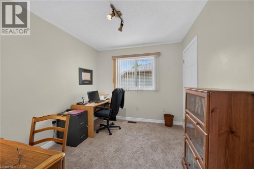 Neutral wall paint, track lighting, window with blinds, and light-toned carpet flooring - 10 Balvenie Boulevard, Caledonia, ON 