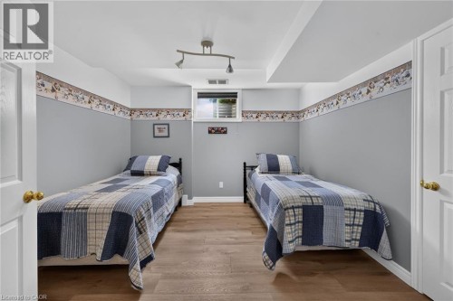Wood-finish flooring, recessed lighting, and wall-mounted track lighting - 10 Balvenie Boulevard, Caledonia, ON 