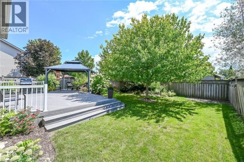 Expansive lawn area, mature shade tree, composite deck with white railings, stepped deck access, and a dedicated gazebo area - 10 Balvenie Boulevard, Caledonia, ON 