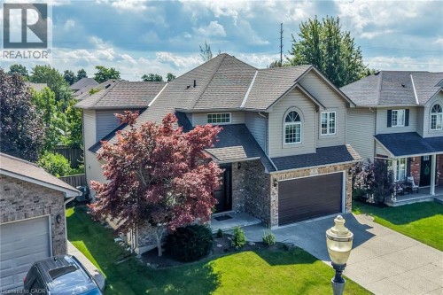 Two-story home with a stone and siding exterior, an attached two-car garage, and a concrete driveway - 10 Balvenie Boulevard, Caledonia, ON 