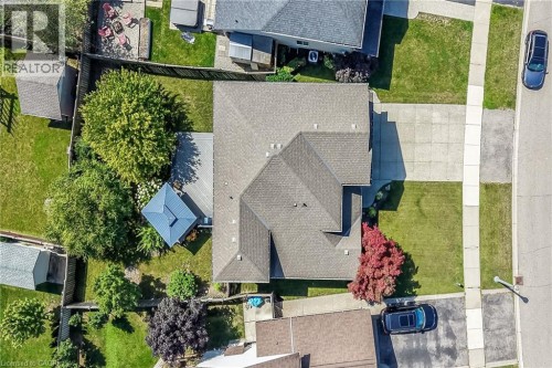 Gabled roofline, concrete driveway, sidewalk, mature trees, and fenced perimeter - 10 Balvenie Boulevard, Caledonia, ON 