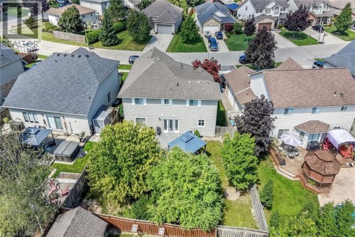 Expansive backyard featuring a manicured lawn, established trees, and a multi-level deck - 10 Balvenie Boulevard, Caledonia, ON 