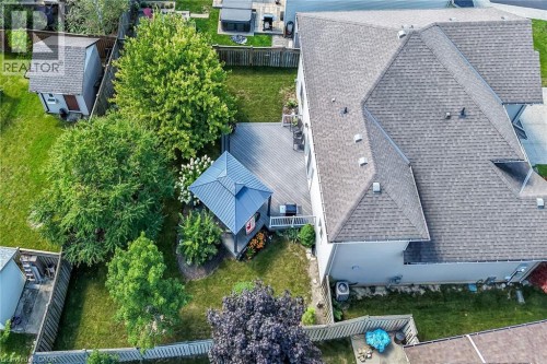 Expansive backyard featuring a large composite deck, covered gazebo, mature trees, and a manicured lawn - 10 Balvenie Boulevard, Caledonia, ON 