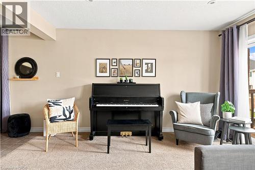 Neutral wall paint throughout, recessed ceiling lighting, textured carpet flooring, and a glass-paneled exterior door - 187 Eden Oak Trail, Kitchener, ON 