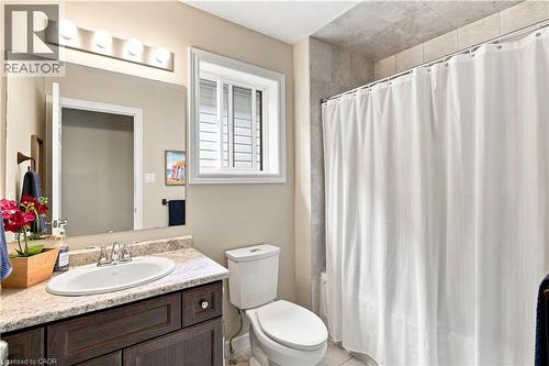 Vanity with an integrated sink, polished chrome faucet, and stone-finish countertop - 187 Eden Oak Trail, Kitchener, ON 