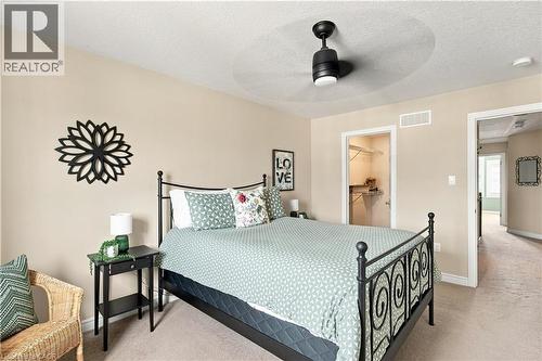 Recessed lighting, ceiling fan, and neutral wall paint complement the bedroom's design - 187 Eden Oak Trail, Kitchener, ON 