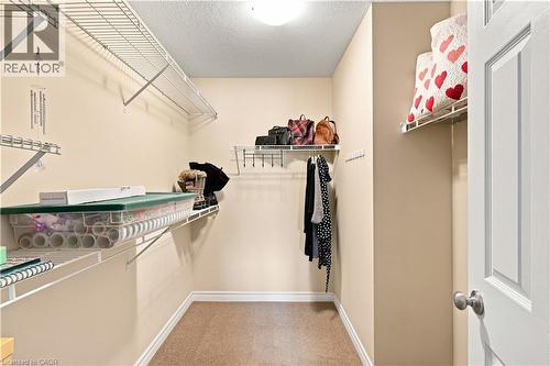 Walk-in closet featuring wire shelving, hanging rods, and neutral wall paint - 187 Eden Oak Trail, Kitchener, ON 