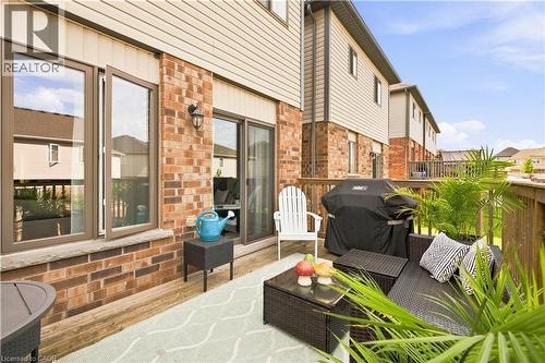 Expansive wood-finish deck with brick and siding exterior - 187 Eden Oak Trail, Kitchener, ON 