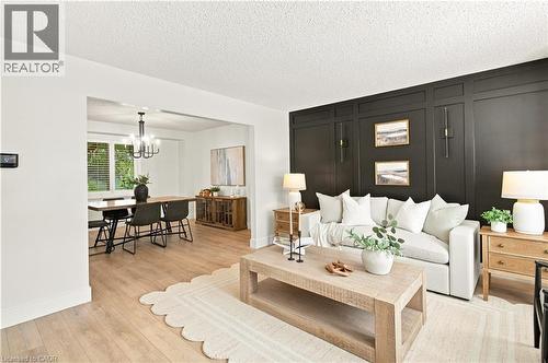 Accent wall with decorative paneling and integrated wall sconces - 62 Corfield Drive, Kitchener, ON 