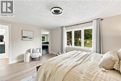 Recessed lighting, wood-finish flooring, and white trim throughout - 62 Corfield Drive, Kitchener, ON 