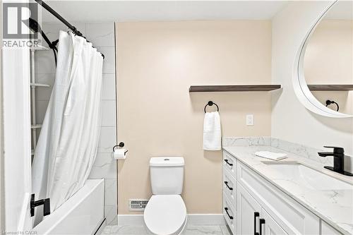 White vanity with dark hardware, a white countertop, and a black faucet - 62 Corfield Drive, Kitchener, ON 