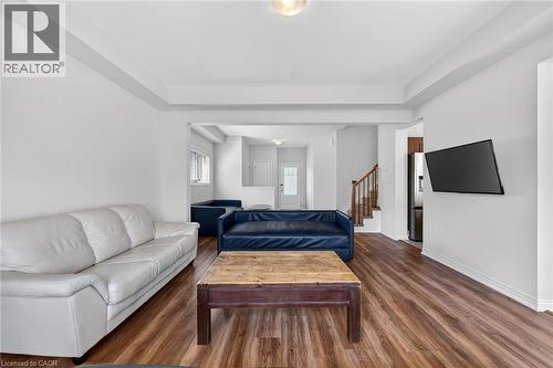 Spacious room featuring wood-finish flooring, white walls, and a recessed ceiling - 9 Winterberry Boulevard, Thorold, ON 
