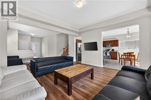 Expansive living area with wood-finish flooring, recessed lighting, and an open concept layout - 9 Winterberry Boulevard, Thorold, ON 