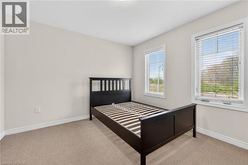 Neutral wall paint, carpet flooring, and two windows with blinds - 9 Winterberry Boulevard, Thorold, ON 