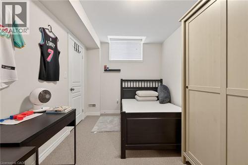 Carpeted room with a small window, built-in wall shelf, and light-toned walls - 9 Winterberry Boulevard, Thorold, ON 