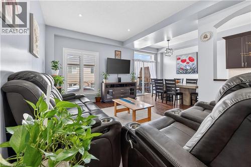 Open concept living area with recessed lighting, wood-finish flooring, and white window shutters - 88 Highgate Drive, Hamilton, ON 