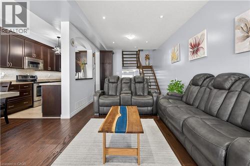 Expansive wood-finish flooring throughout, recessed ceiling lighting, and a contemporary open staircase with wood treads - 88 Highgate Drive, Hamilton, ON 