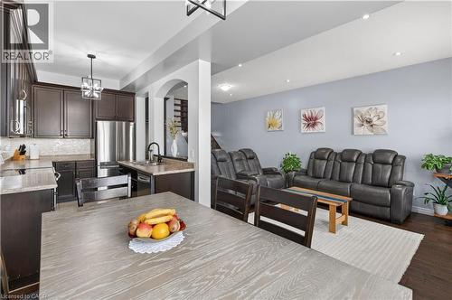 Dark wood-finish cabinetry, stainless steel appliances, recessed ceiling lighting, and archway architectural detailing - 88 Highgate Drive, Hamilton, ON 