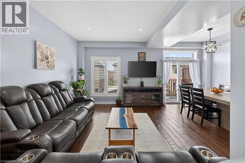 Wood-finish flooring throughout, recessed lighting, and a sliding glass door - 88 Highgate Drive, Hamilton, ON 