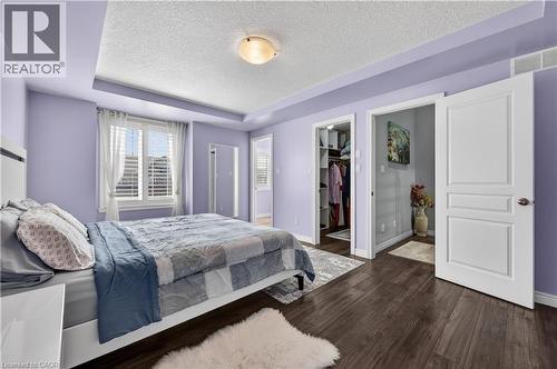 Recessed tray ceiling, wood-finish flooring, white plantation shutters, built-in closet organization, and paneled interior doors - 88 Highgate Drive, Hamilton, ON 