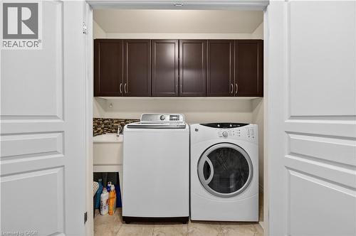 Built-in cabinetry, utility sink, and tile flooring - 88 Highgate Drive, Hamilton, ON 