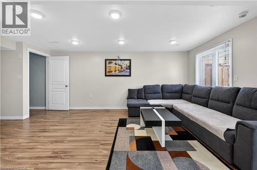 Recessed lighting, wood-finish flooring, white trim, and a window with blinds - 88 Highgate Drive, Hamilton, ON 