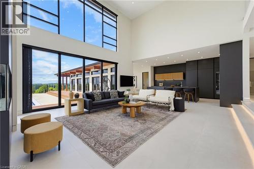 Soaring ceilings with clerestory windows flood this open-concept living space with natural light - 5709 Forth Line, Hillsburg, ON 