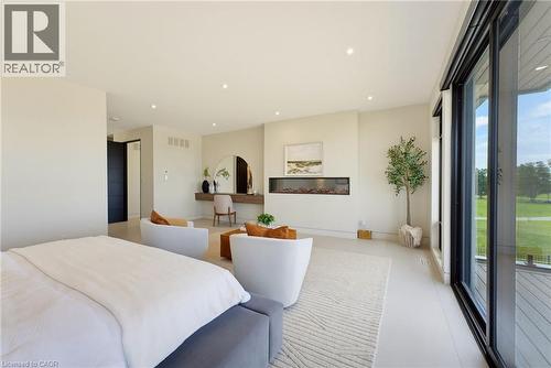 Recessed lighting, floor-to-ceiling sliding glass doors, built-in linear fireplace, light-toned flooring, and a built-in vanity - 5709 Forth Line, Hillsburg, ON 