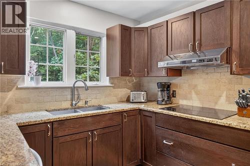Kitchen featuring wood cabinetry, granite countertops,  tile backsplash,  stainless steel appliances - 2023 Latimer Crescent, Greater Sudbury, ON 