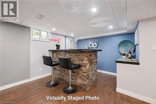 Stone-clad wet bar featuring a dark countertop - 345 Beechlawn Drive, Waterloo, ON 