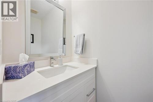Vanity with an integrated rectangular sink, chrome faucet, and a large mirrored cabinet - 151 Clairfields Drive Unit# 3, Guelph, ON 