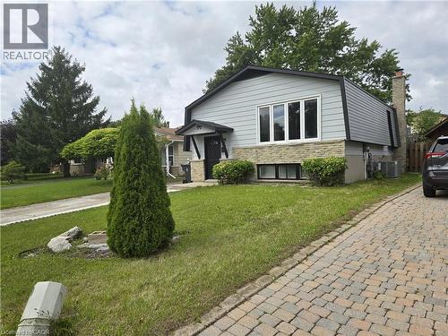 Split-level residence featuring light gray siding, a stone facade, and a dark asphalt roof - 99 Cluthe Crescent, Kitchener, ON 