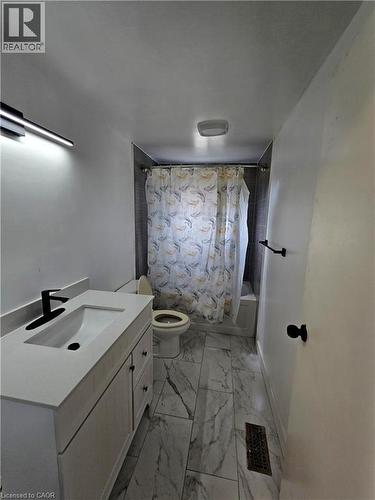 White vanity with integrated sink, black-finish faucet, and coordinating hardware - 99 Cluthe Crescent, Kitchener, ON 