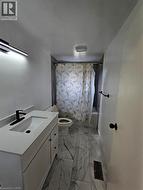 White vanity with integrated sink, black-finish faucet, and coordinating hardware - 
