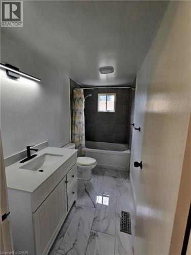 White vanity with a rectangular undermount sink and matte black faucet - 99 Cluthe Crescent, Kitchener, ON 