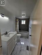 White vanity with a rectangular undermount sink and matte black faucet - 