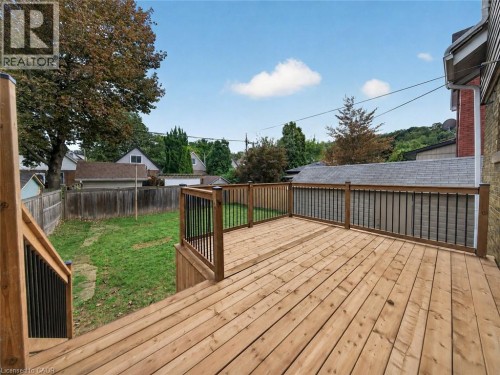 Expansive wood deck with wood railings and black metal spindles - 229 Park Row S, Hamilton, ON 