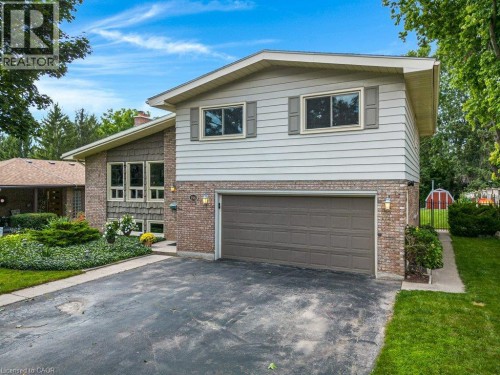 Brick and siding exterior featuring a two-car garage - 196 Abraham Street, Cambridge, ON 