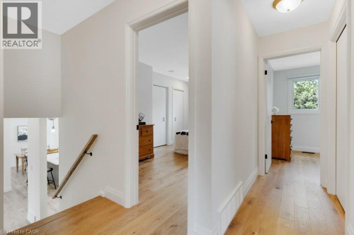 Bright hallway with warm wood-finish flooring, white walls, and recessed ceiling lighting - 196 Abraham Street, Cambridge, ON 