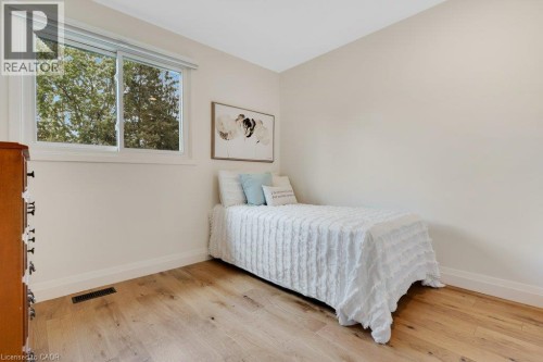 Light-toned wood-finish flooring, white trim, and a white framed window - 196 Abraham Street, Cambridge, ON 