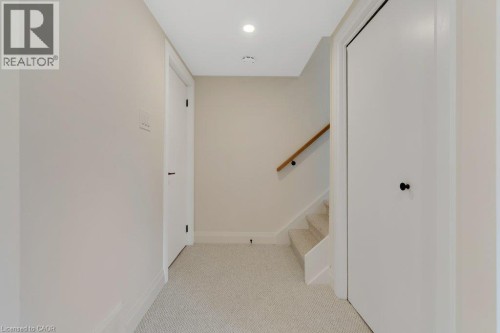 Carpeted flooring, recessed lighting, wood handrail, and white paneled doors - 196 Abraham Street, Cambridge, ON 