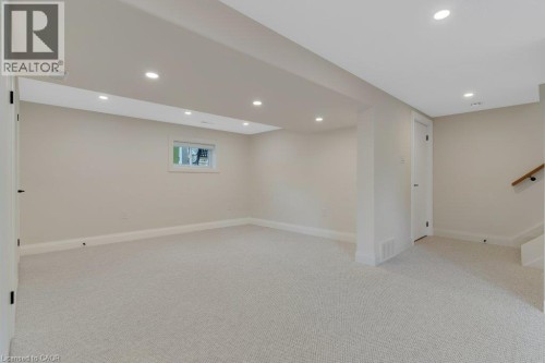 Plush carpeting, recessed lighting, neutral wall tones, white trim, and a window for natural light - 196 Abraham Street, Cambridge, ON 