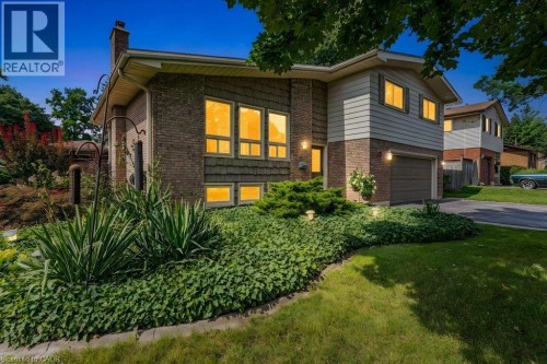 Modern brick and siding exterior with expansive front-facing windows featuring warm interior lighting - 196 Abraham Street, Cambridge, ON 
