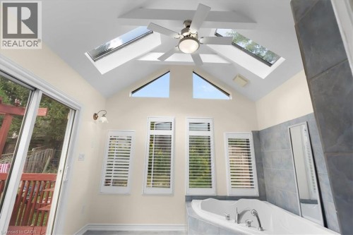 Vaulted ceiling with exposed beams, multiple skylights, and a ceiling fan - 150 Bankside Drive, Kitchener, ON 