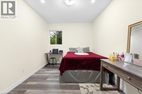 Recessed lighting, wood-finish flooring, white walls, and a window for natural light - 150 Bankside Drive, Kitchener, ON 