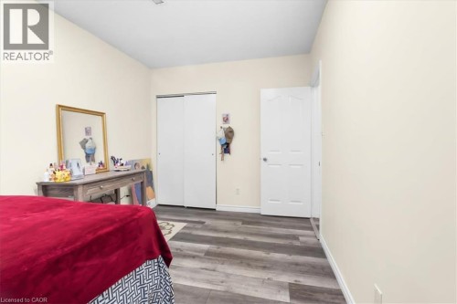 Wood-finish flooring and light-toned walls - 150 Bankside Drive, Kitchener, ON 