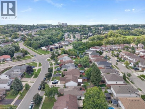 Aerial perspective showcasing residential streets, mature trees, and multiple housing units - 150 Bankside Drive, Kitchener, ON 