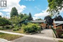 Brick exterior featuring a gabled roofline and an asphalt driveway - 229 Winfield Avenue, Waterloo, ON 
