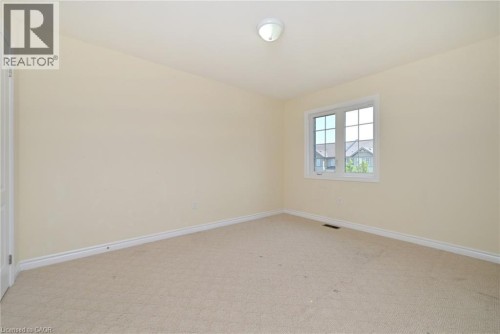 Neutral tone wall finish, white trim, recessed window with white frame, and wall-to-wall carpeting - 64 Maple Cider Street, Caledon, ON 